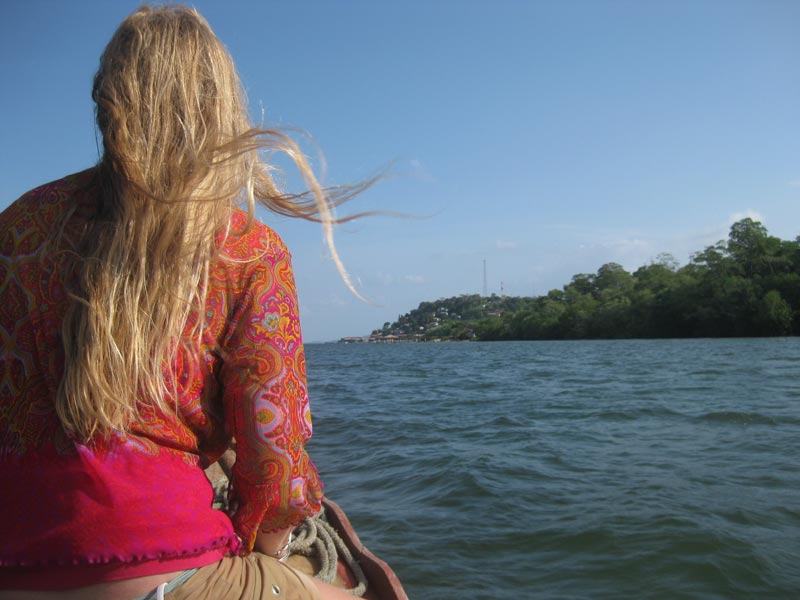 When the water calms down again Riana sits on the bow of the boat and enjoys the ride. La Palma is off in the distance.